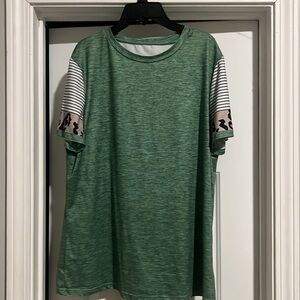 Green top with leopard print sleeves.